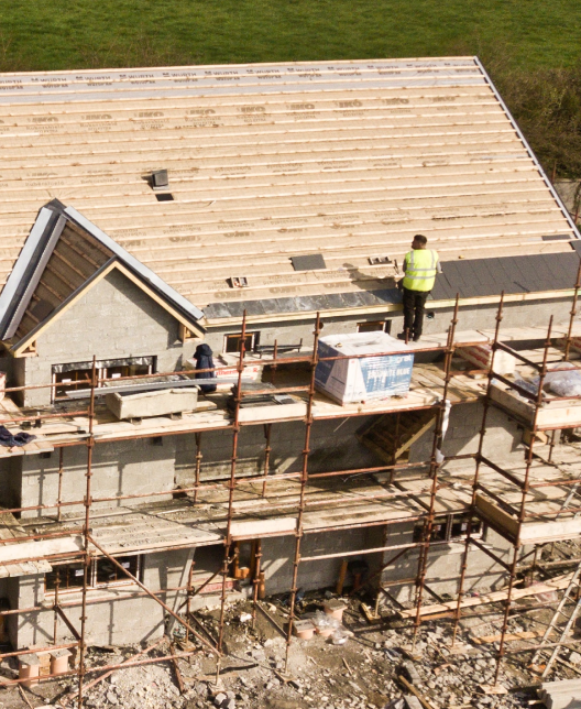 Workers constructing a home roof during a remodeling project